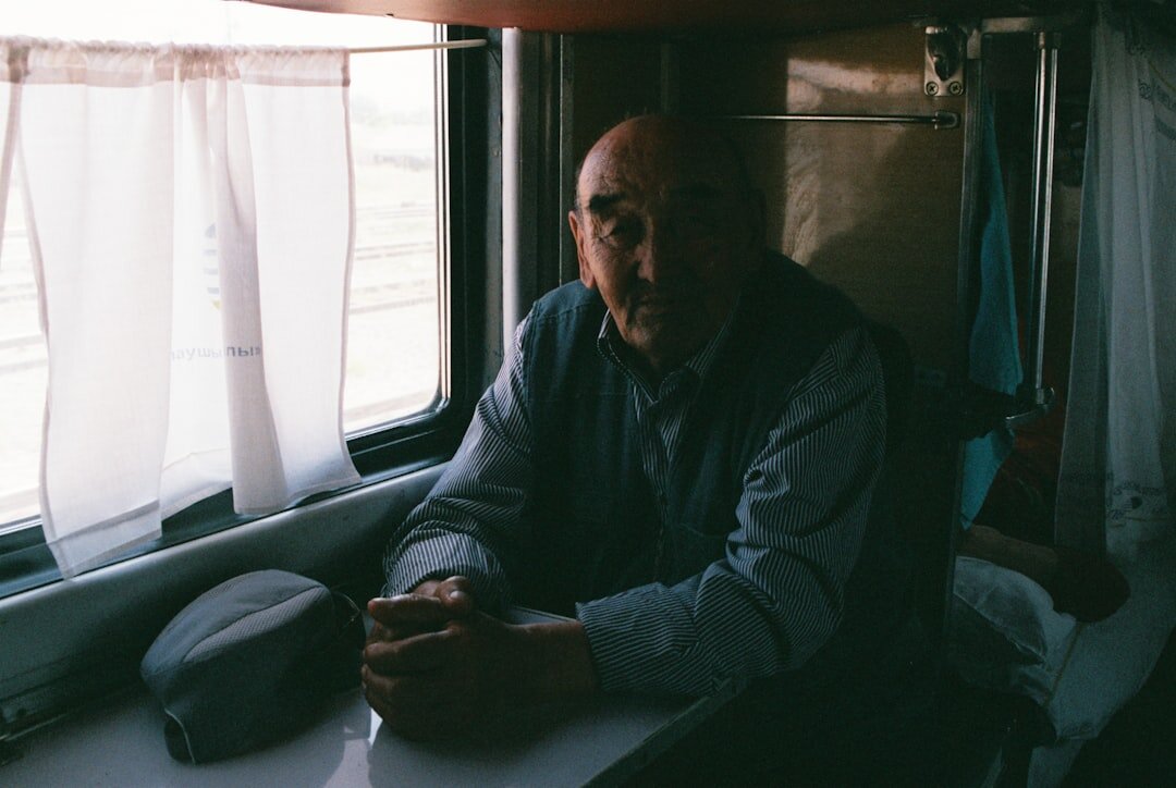 elderly man sitting by window